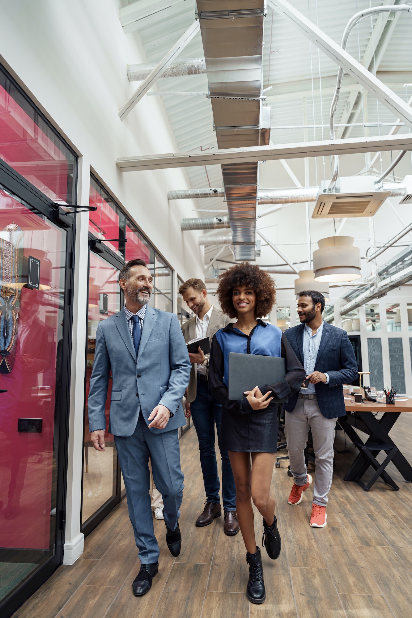 Group of multiethnic business people crossing office together