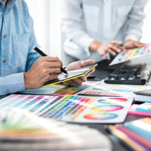 Team of creative graphic designer working on color swatch samples chart for selection coloring